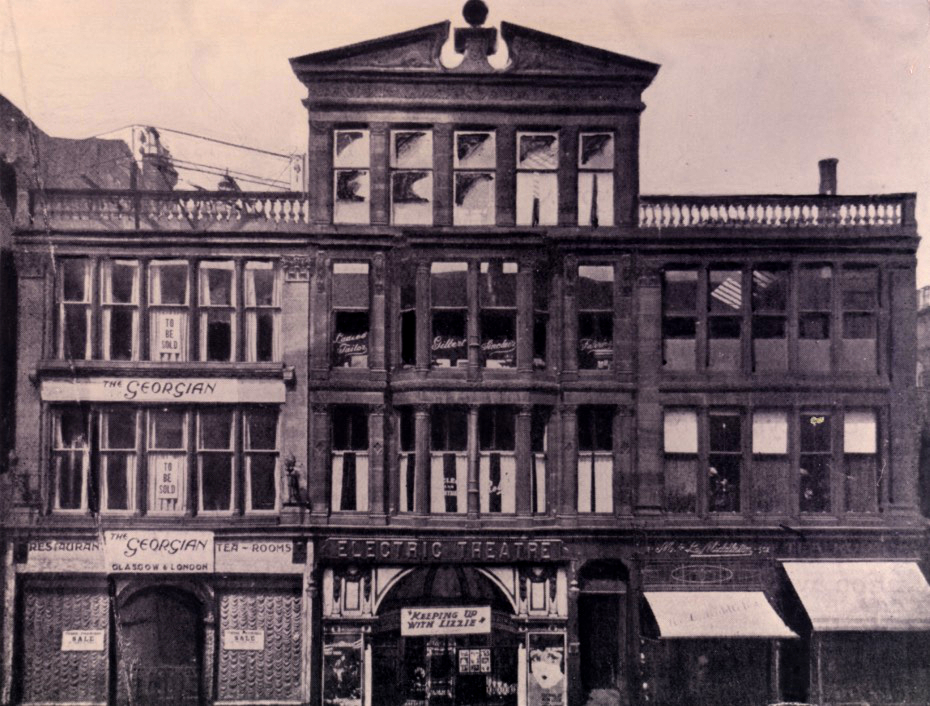 A black and white photograph of a large four storey building with a sign saying Electric Theatre.